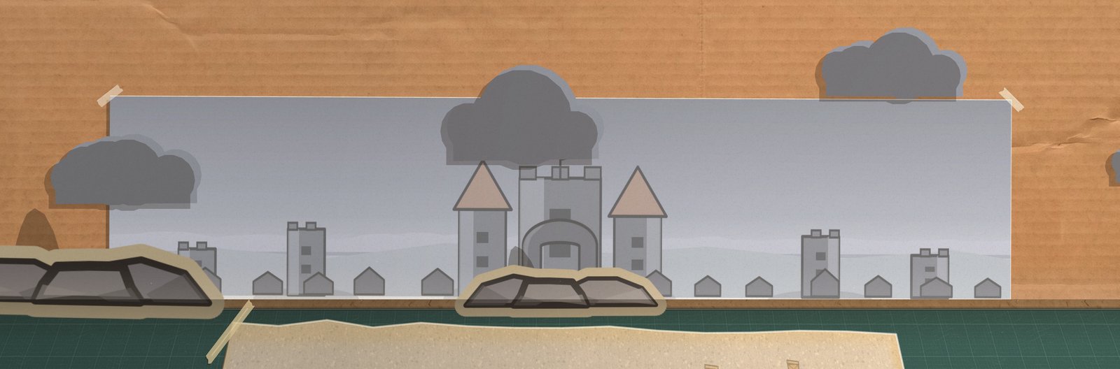 The arena box from the front with the Castle card taped to the kraft back wall: a grey curtain wall with a gatehouse, towers and a town of gabled roofs, cut-paper clouds standing off the wall, and the mat with its lanes below